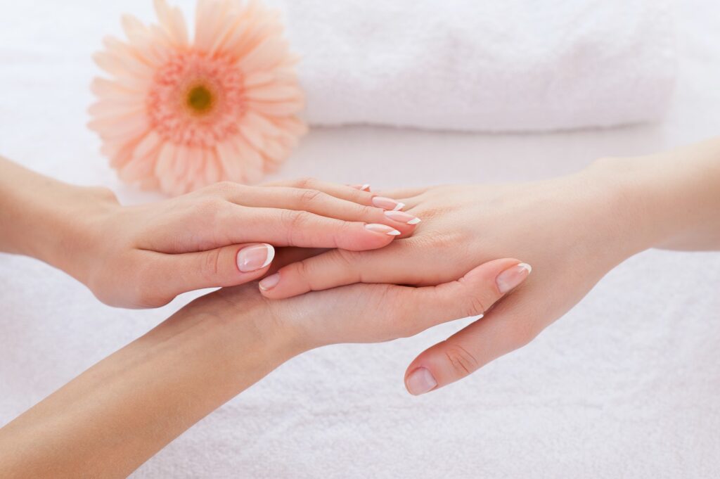 Hands care. Close-up of massage therapist massaging hands of female customer